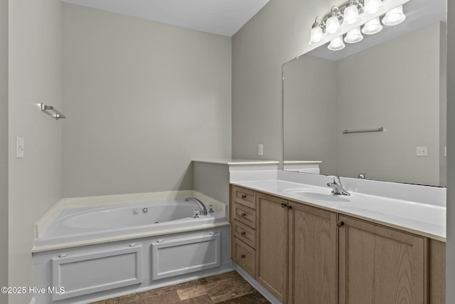 full bathroom featuring a garden tub, stone finish floor, and vanity