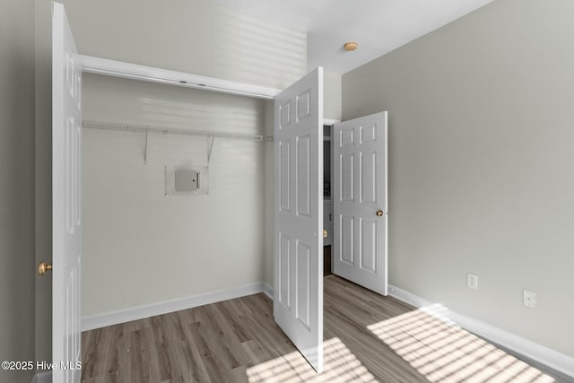 interior space with baseboards and wood finished floors