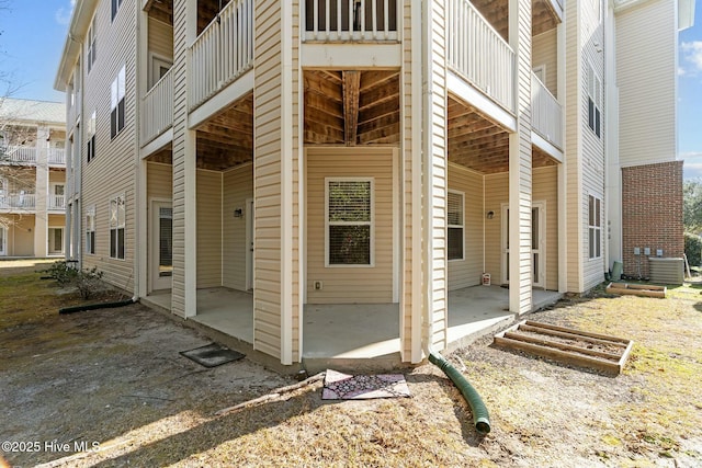 view of home's exterior with cooling unit and a patio area