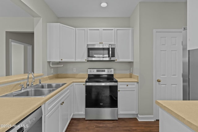 kitchen featuring stainless steel appliances, white cabinets, and a sink