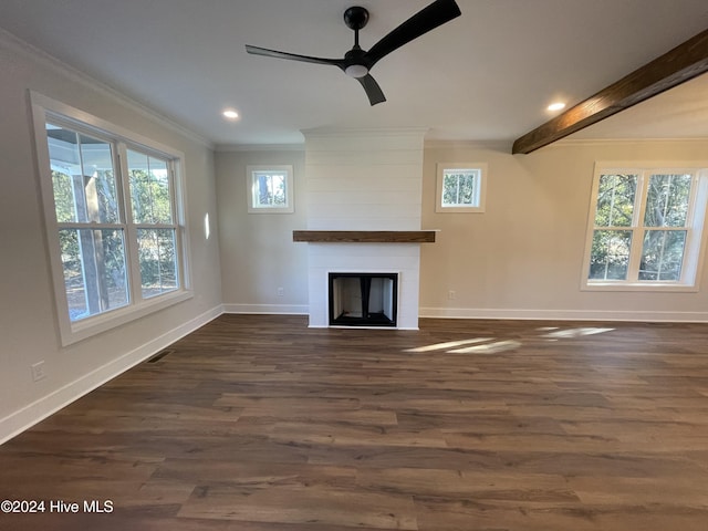 unfurnished living room with baseboards, visible vents, ornamental molding, dark wood-style flooring, and a fireplace