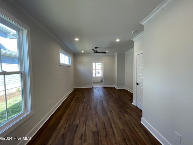 empty room featuring dark wood-style floors, recessed lighting, baseboards, and ornamental molding