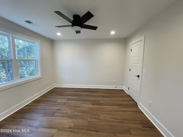 empty room featuring dark wood-style floors, recessed lighting, visible vents, ceiling fan, and baseboards