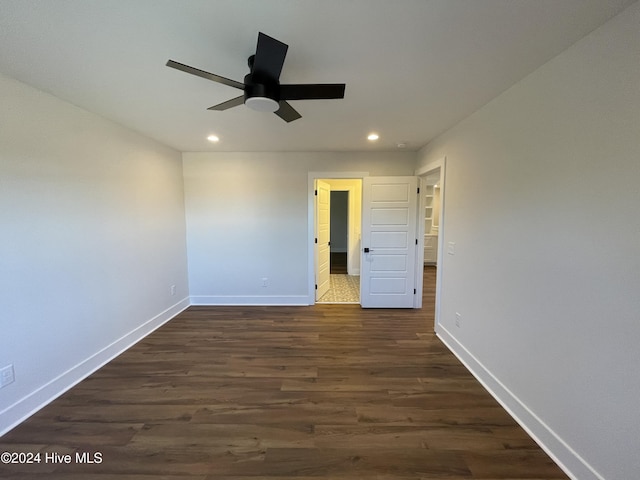 unfurnished bedroom with baseboards, dark wood-style flooring, and recessed lighting