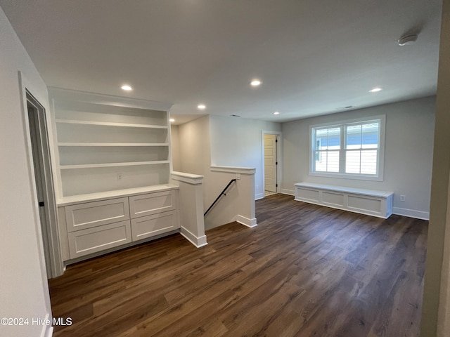 spare room with baseboards, dark wood-style flooring, and recessed lighting