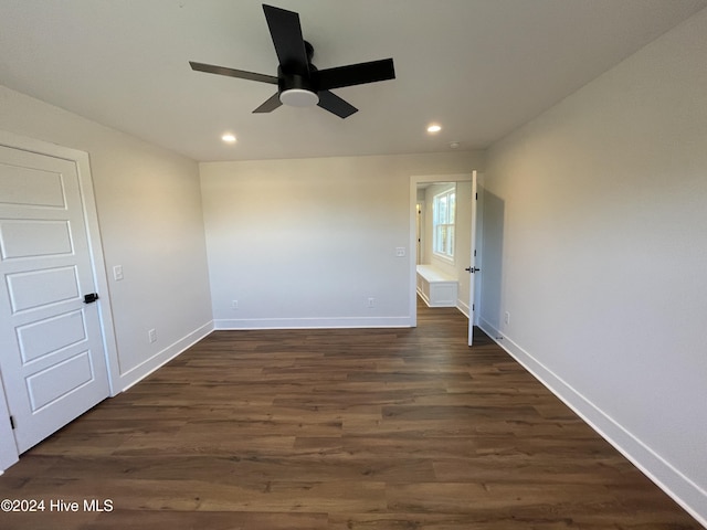 empty room featuring baseboards, dark wood finished floors, a ceiling fan, and recessed lighting