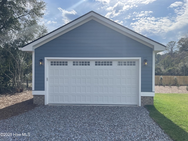 detached garage featuring fence