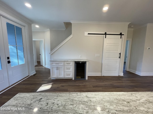 bar featuring a barn door, wine cooler, ornamental molding, dark wood-style flooring, and recessed lighting