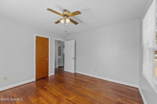 unfurnished bedroom featuring hardwood / wood-style flooring, ceiling fan, and baseboards