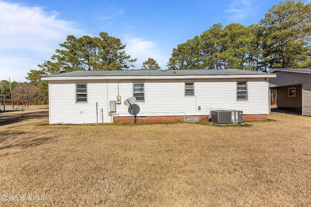 back of property featuring crawl space, central AC unit, and a yard