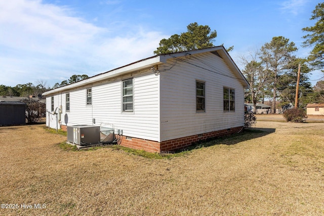 view of home's exterior with central AC, a yard, and crawl space