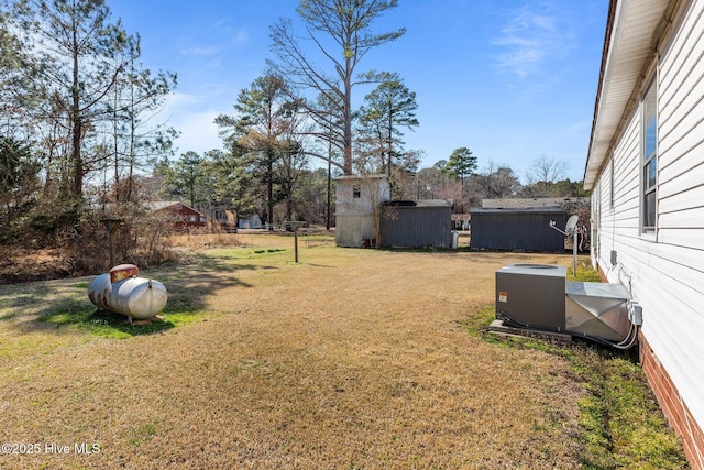 view of yard with a shed, an outdoor structure, and cooling unit