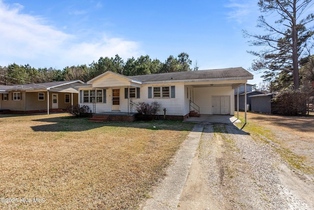 ranch-style house with driveway, a carport, a porch, and a front yard