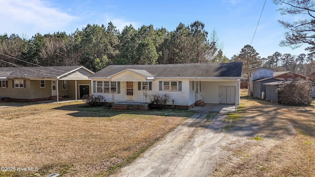 ranch-style home with a front yard and dirt driveway