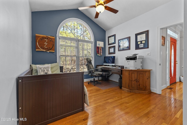 office area featuring lofted ceiling, ceiling fan, baseboards, and wood finished floors