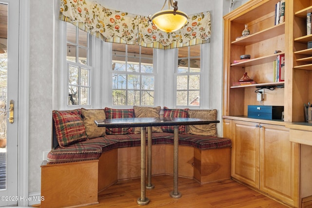 dining space featuring breakfast area and light wood-style floors