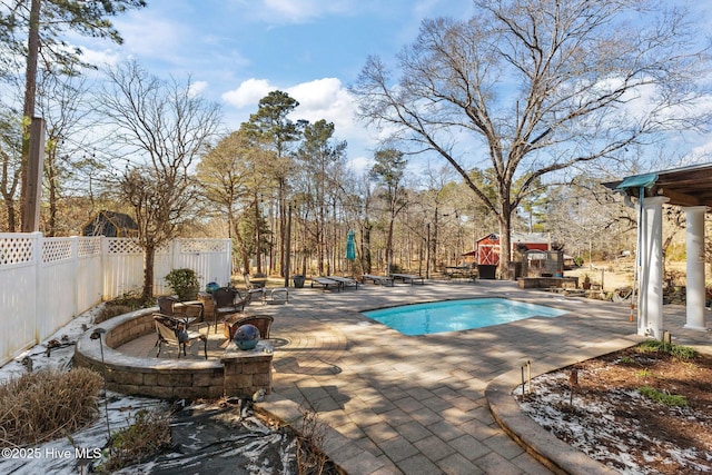 outdoor pool featuring a patio area and fence