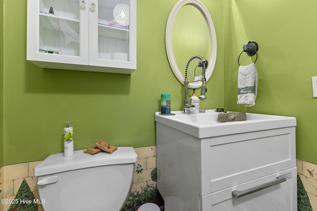 bathroom with toilet and vanity