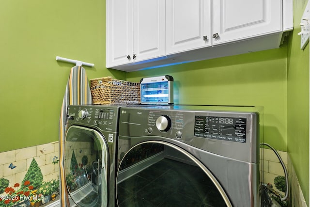 laundry room with cabinet space, washer and dryer, and tile patterned floors