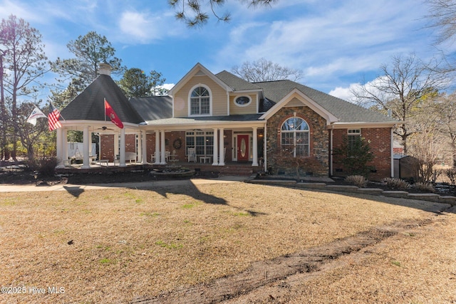 view of front facade featuring a front lawn and brick siding