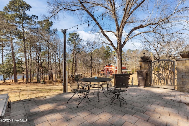 view of patio / terrace featuring outdoor dining space and a gate