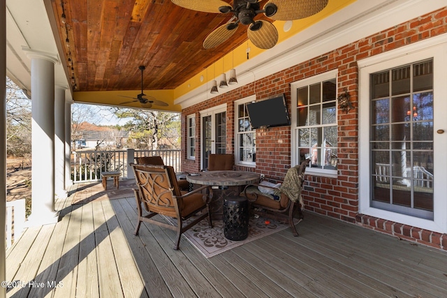 wooden terrace with a ceiling fan