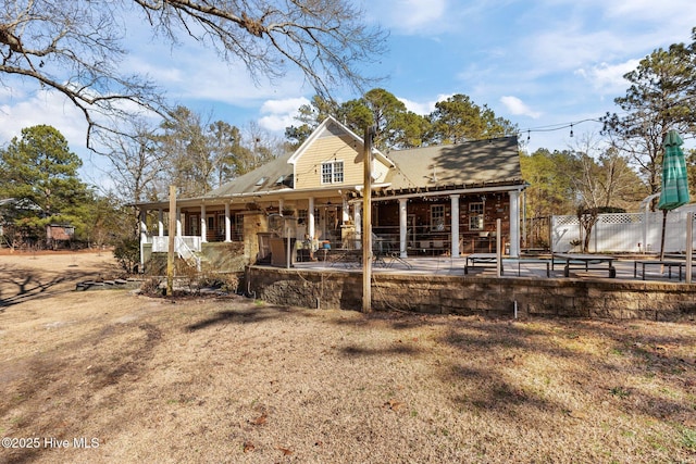 rear view of property with a patio area and fence