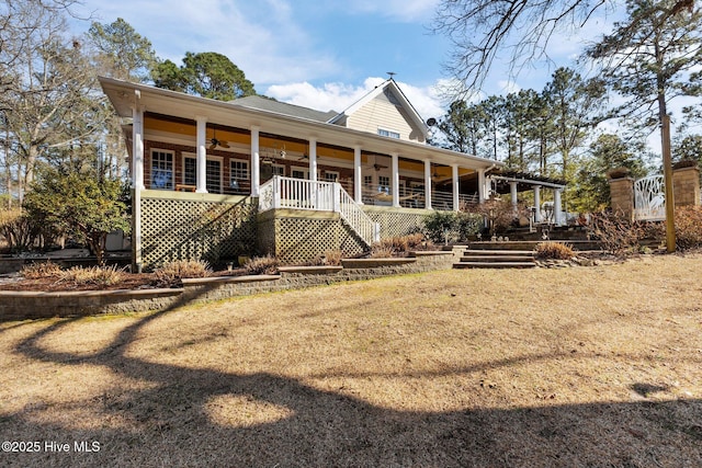 back of house featuring covered porch, stairway, and a ceiling fan