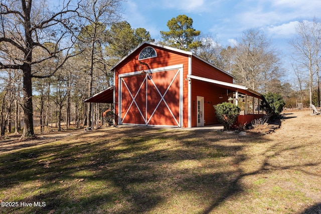 view of barn with a lawn