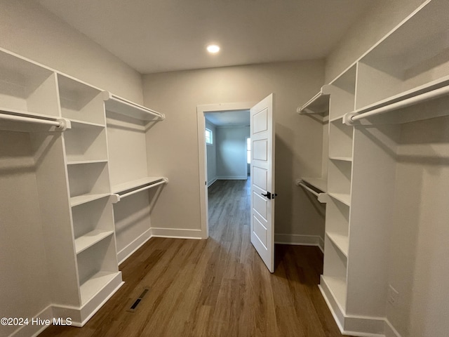 walk in closet featuring dark wood-style floors and visible vents