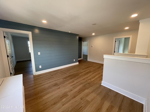 empty room featuring baseboards, wood finished floors, and recessed lighting