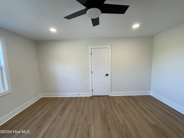 unfurnished room with ceiling fan, baseboards, wood finished floors, and recessed lighting