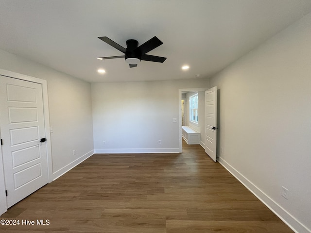 unfurnished room with a ceiling fan, recessed lighting, dark wood finished floors, and baseboards