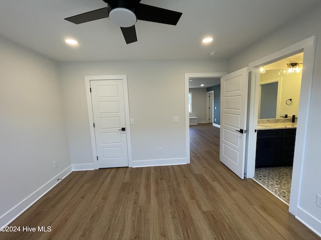 empty room with a ceiling fan, recessed lighting, baseboards, and wood finished floors