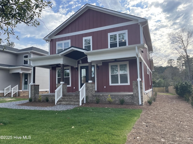 view of front of property featuring a porch, board and batten siding, and a front lawn