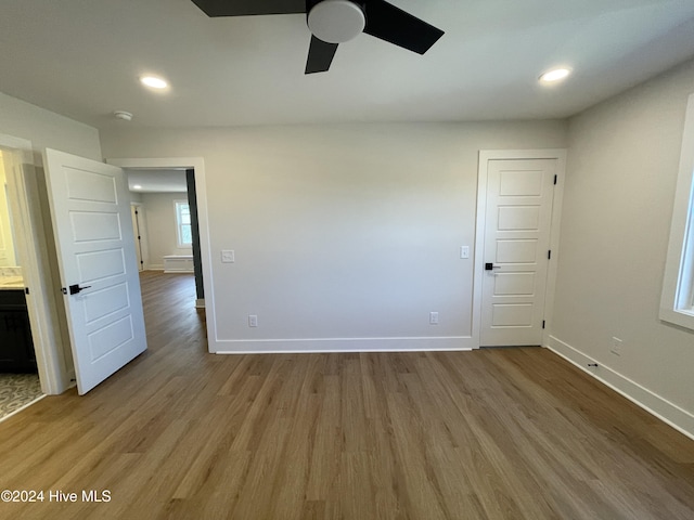 unfurnished room with recessed lighting, light wood-style flooring, and baseboards