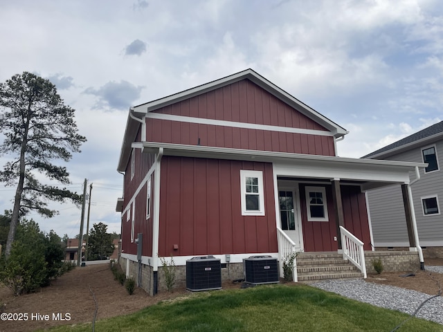 view of front of property with entry steps, central AC unit, and board and batten siding