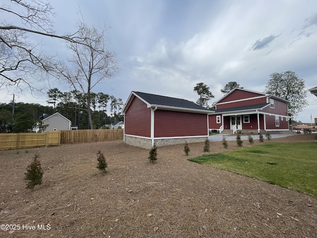 exterior space featuring fence and a front lawn