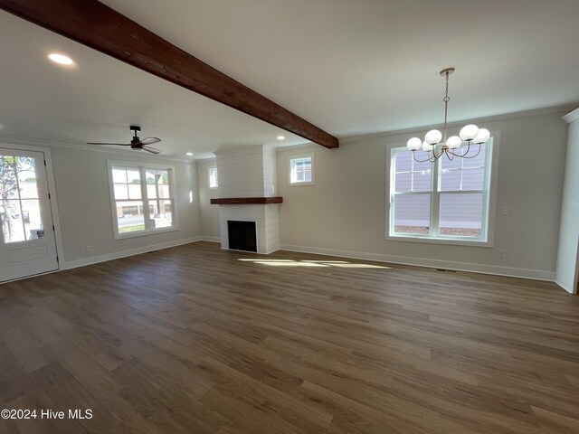 unfurnished living room featuring beamed ceiling, a brick fireplace, wood finished floors, and baseboards