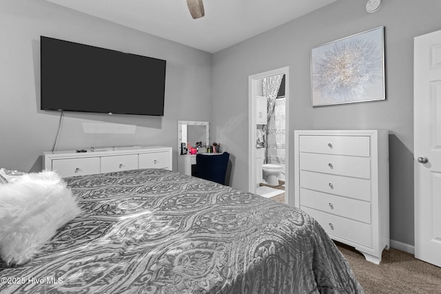 bedroom with ensuite bathroom, carpet floors, and a ceiling fan