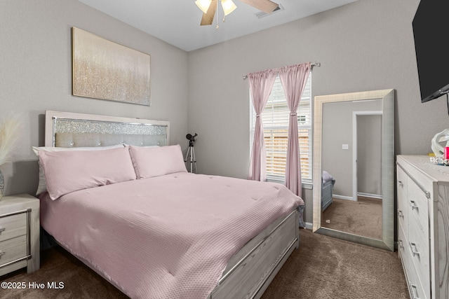 bedroom with visible vents, dark carpet, baseboards, and ceiling fan