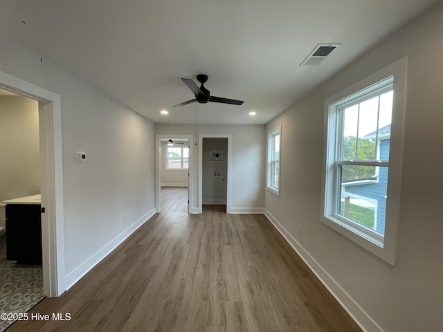 interior space featuring baseboards, visible vents, dark wood-style floors, ceiling fan, and recessed lighting