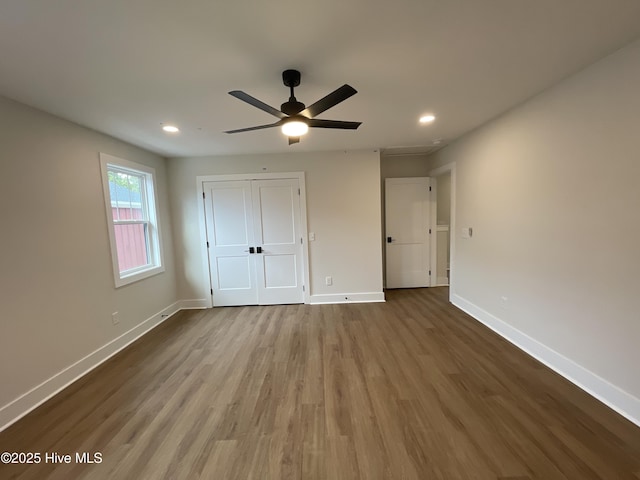 unfurnished bedroom featuring recessed lighting, baseboards, and wood finished floors