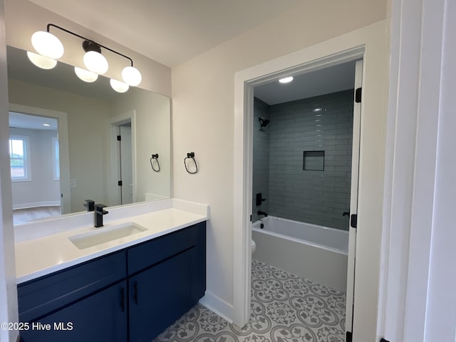 bathroom featuring baseboards, toilet, tile patterned floors, tub / shower combination, and vanity