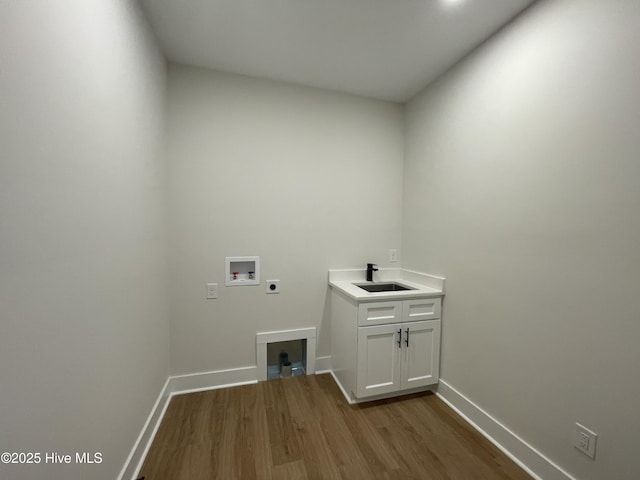 washroom with washer hookup, dark wood-style flooring, cabinet space, hookup for an electric dryer, and a sink