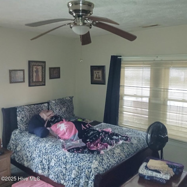 bedroom with visible vents and ceiling fan