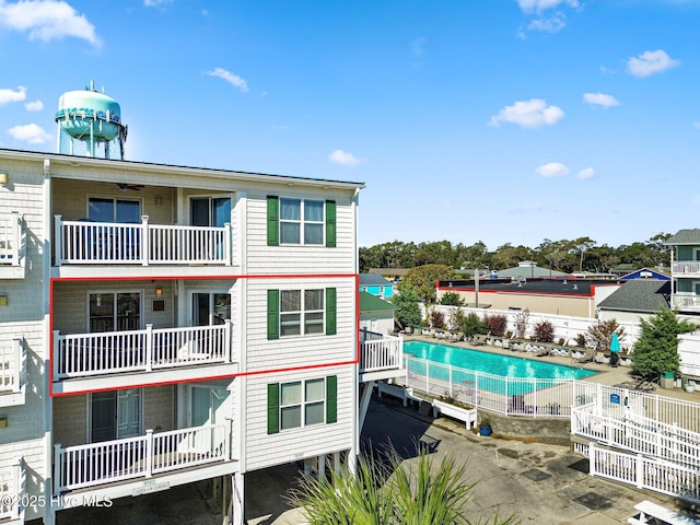 view of building exterior featuring a fenced in pool