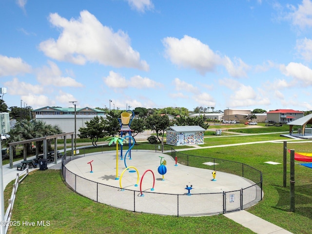 surrounding community featuring playground community, a lawn, and fence