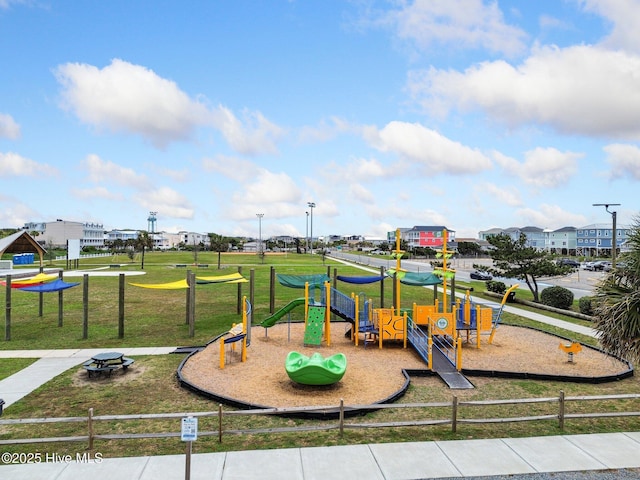 community playground with a yard and fence