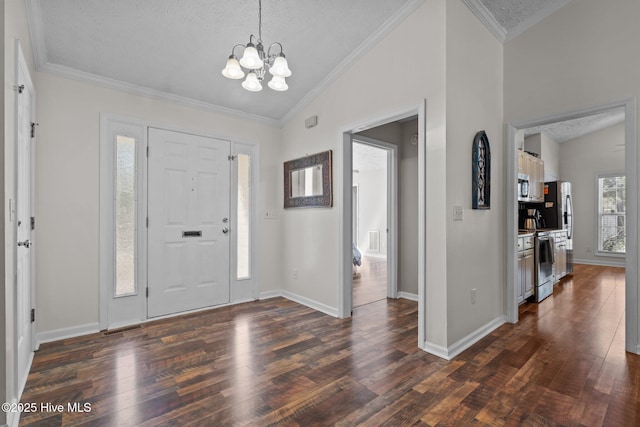 entryway featuring an inviting chandelier, ornamental molding, dark wood-style flooring, and vaulted ceiling